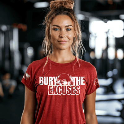 Woman wearing a red t-shirt with 'Bury The Excuses' text in a gym setting