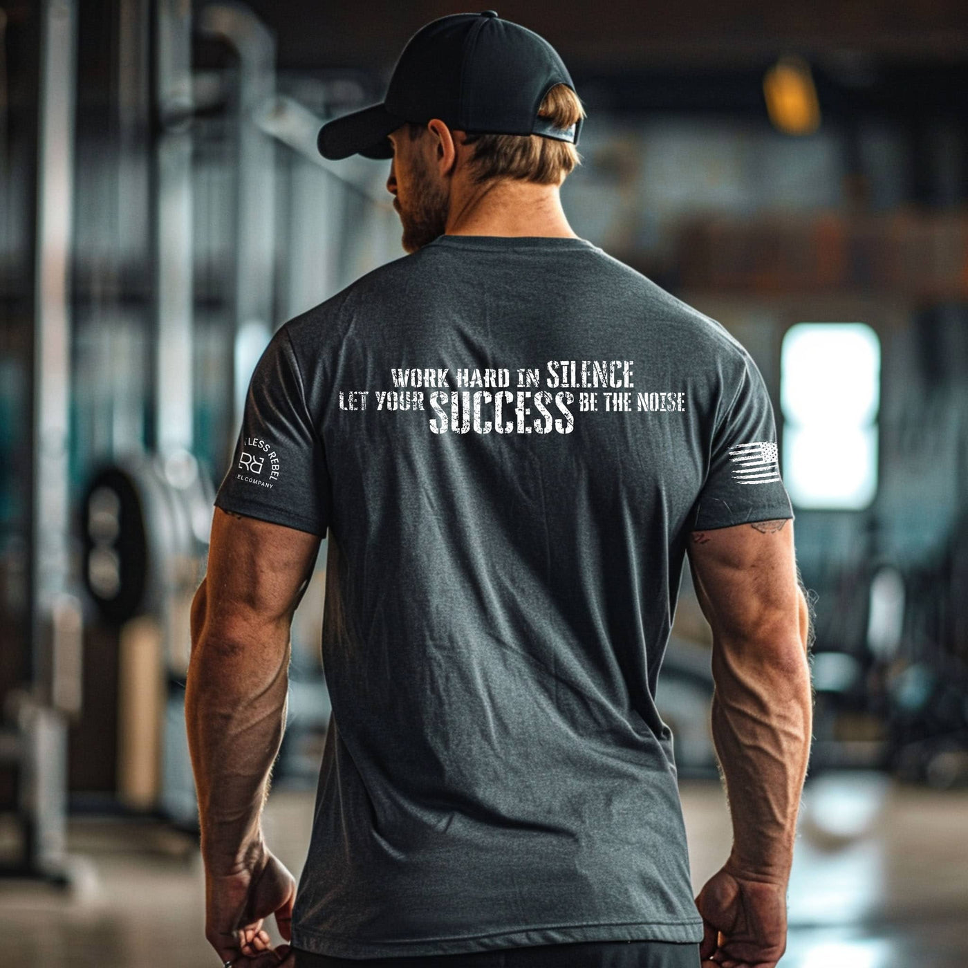 Man wearing a motivational t-shirt with text in a gym setting