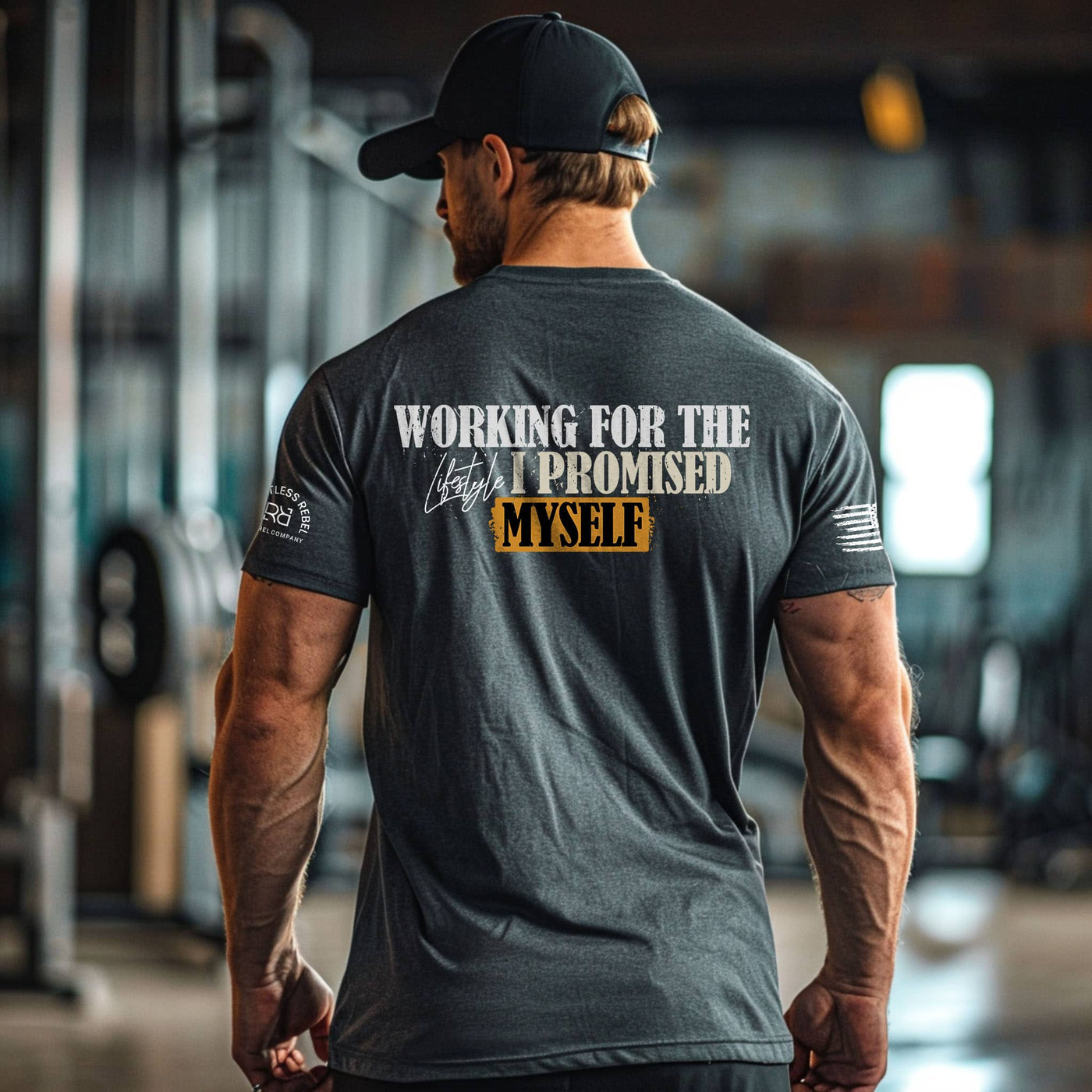 Man wearing a t-shirt with motivational text in a gym setting