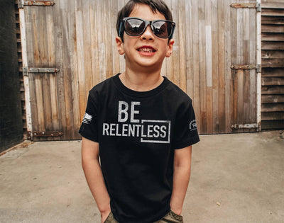Boy wearing Solid Black Youth Be Relentless Front Design Tee