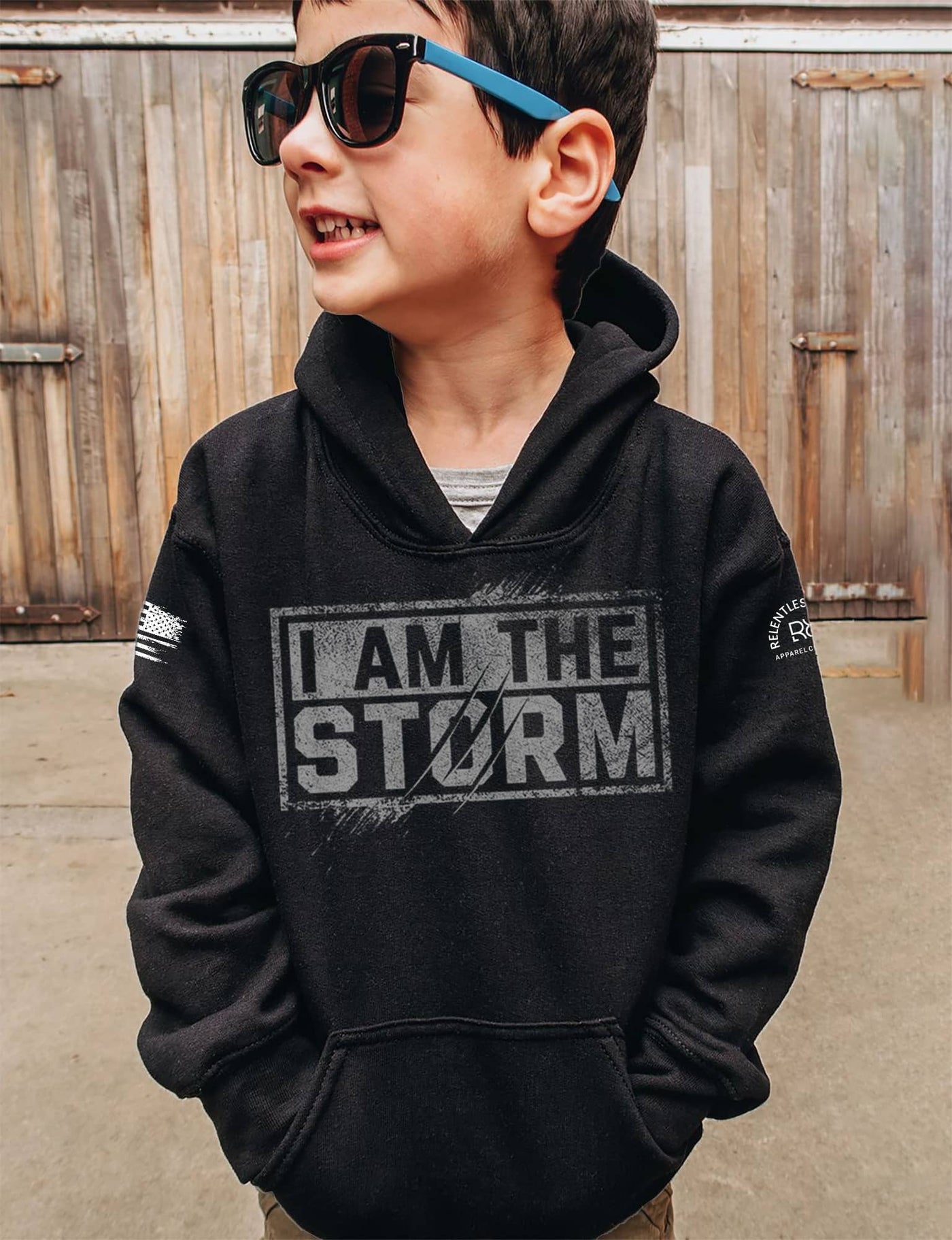 Boy wearing Solid Black Youth I Am The Storm Front Design Hoodie