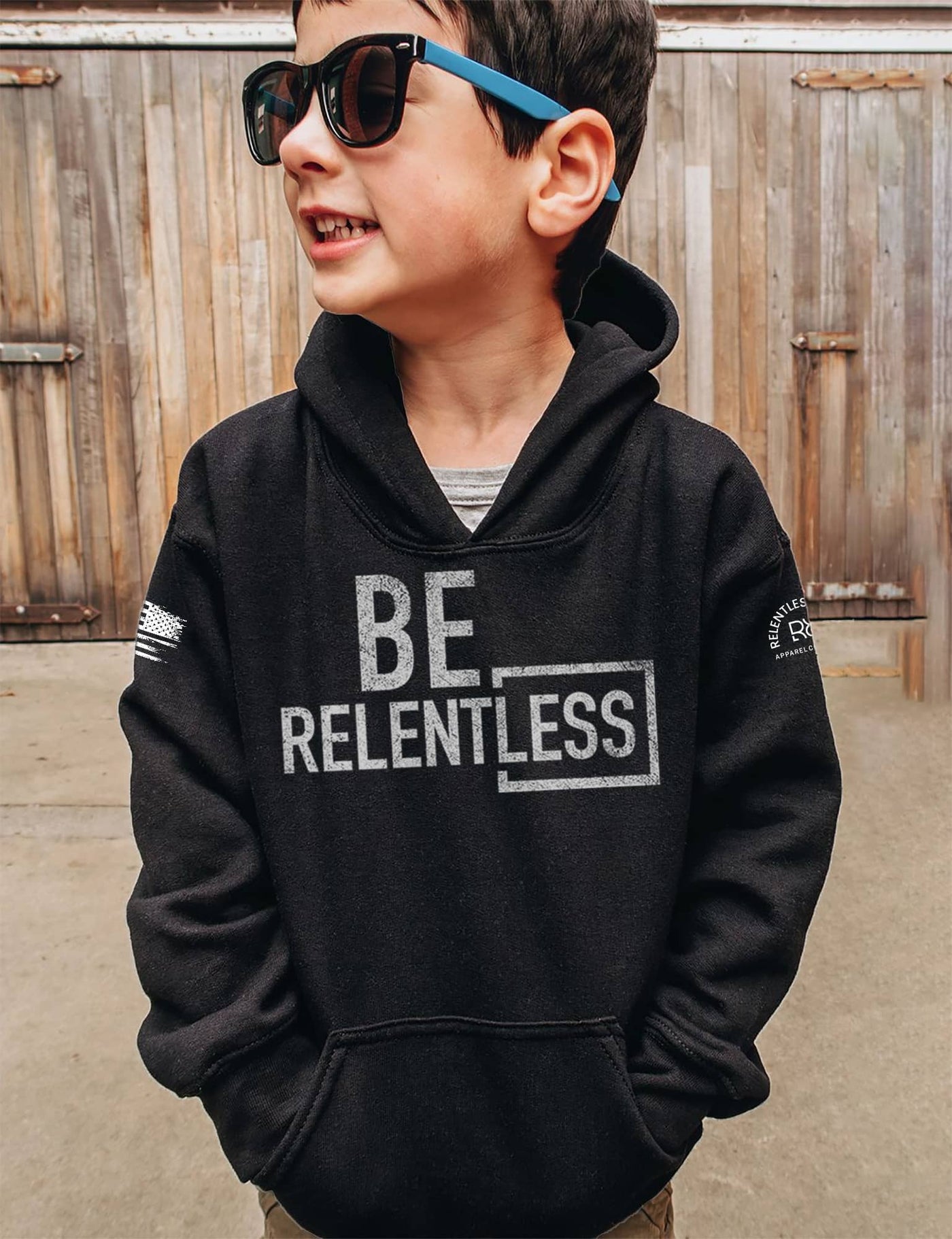 Boy wearing Solid Black Youth Be Relentless Front Design Hoodie
