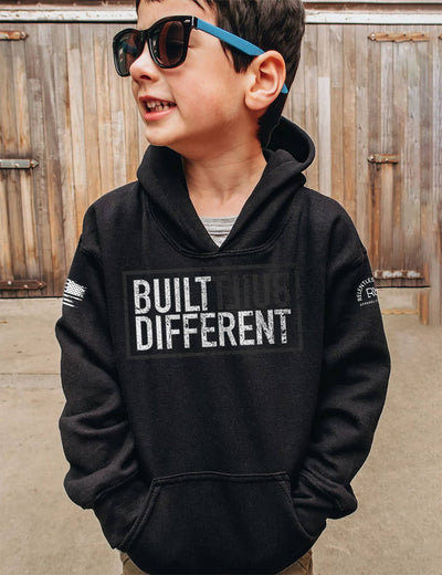 Boy wearing Built Different Youth front design solid black hoodie
