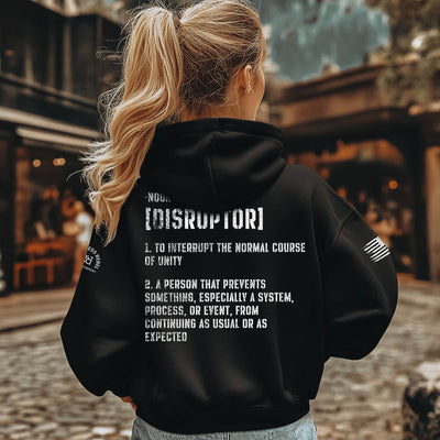 Person wearing a black hoodie with text on the back, standing outdoors.