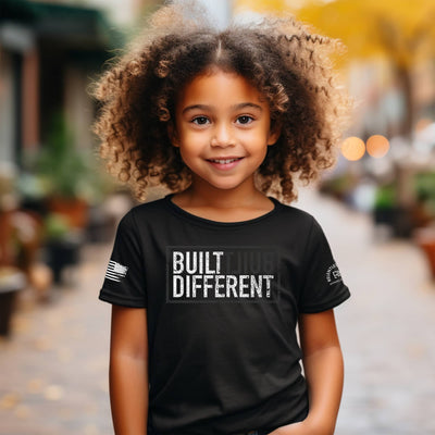 Girl wearing Built Different Youth front design solid black tee