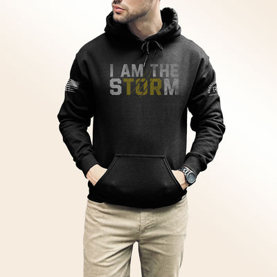 Man wearing Solid Black Men's I Am The Storm Front Design Hoodie