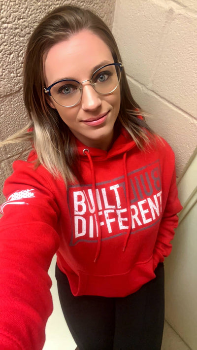 Woman wearing Built Different Women's front design Rebel Red hoodie