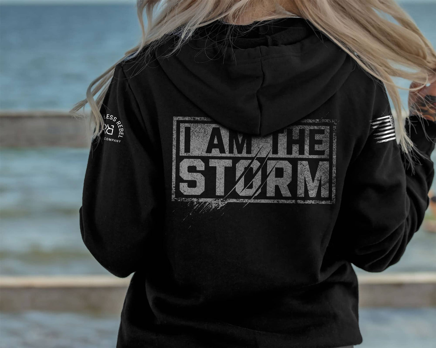 Woman wearing Solid Black Women's I Am The Storm Back Design Hoodie