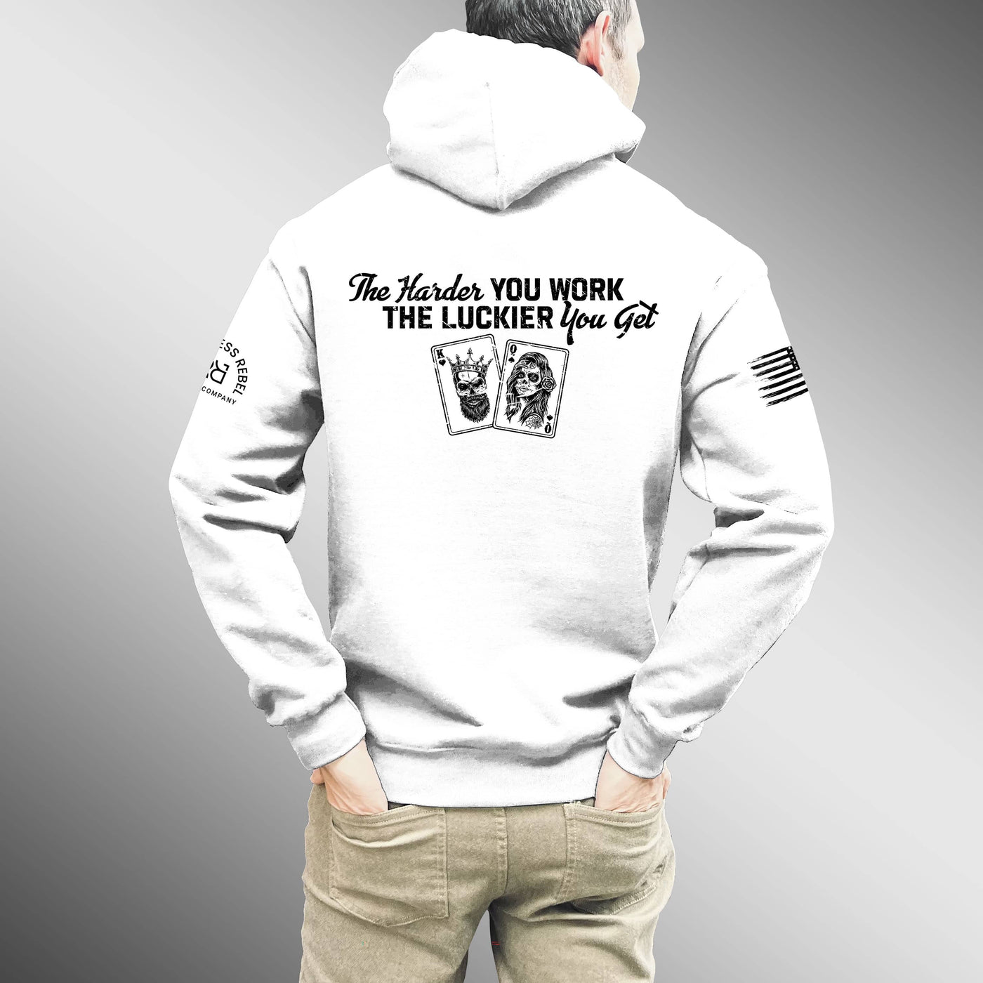White hoodie with text and graphics on the back, worn by a person against a gray background