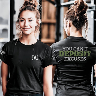 Woman wearing a black t-shirt with a logo on the front and motivational text on the back in a gym setting.