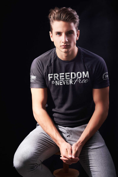 Man wearing Solid Black Men's Freedom Is Never Free Front Design Tee