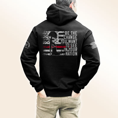 Man wearing Solid Black Men's Be The Change Back Design Hoodie