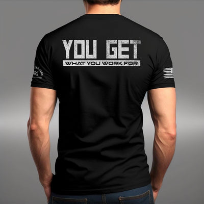 Man wearing Solid Black Men's You Get What You Work For Back Design Tee