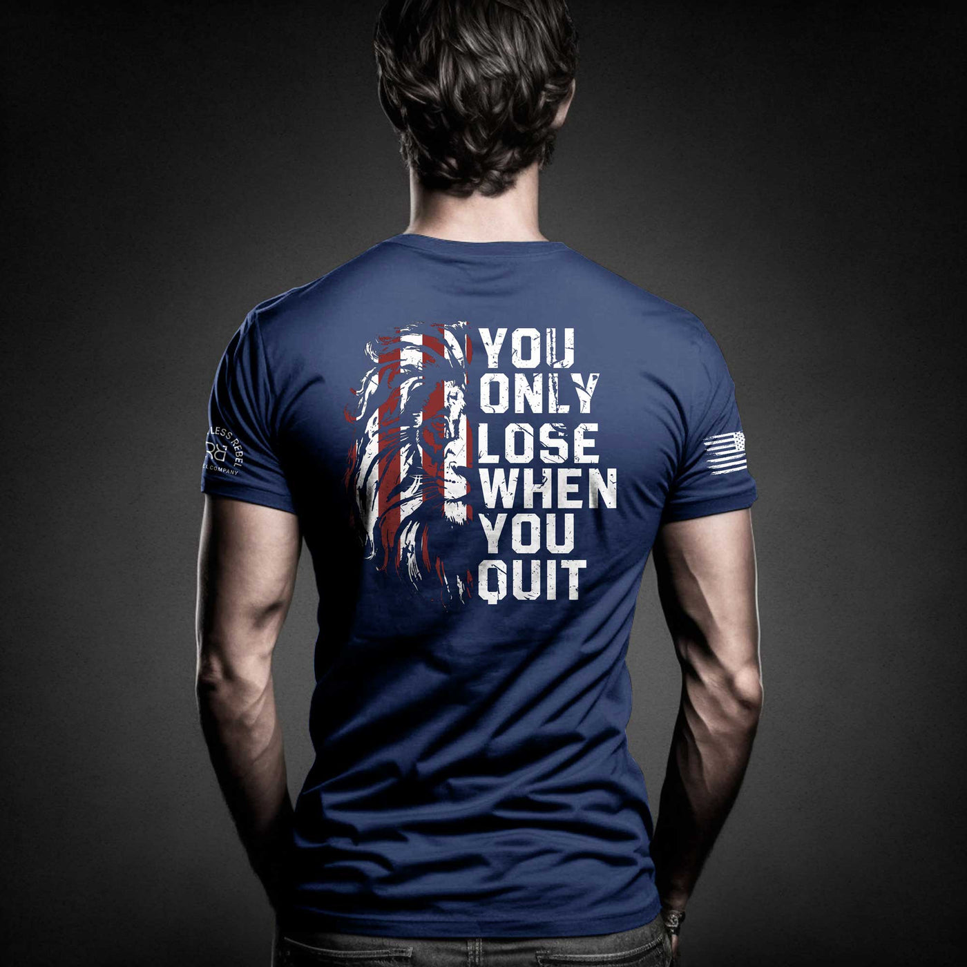 Man wearing Rebel Blue Men's You Only Lose When You Quit Back Design Tee